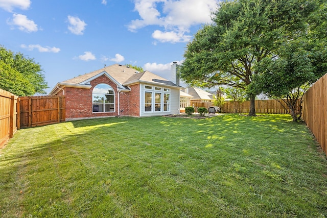12306 Ark Rd, Frisco, TX 75035 - rear view of house with a chimney and brick siding