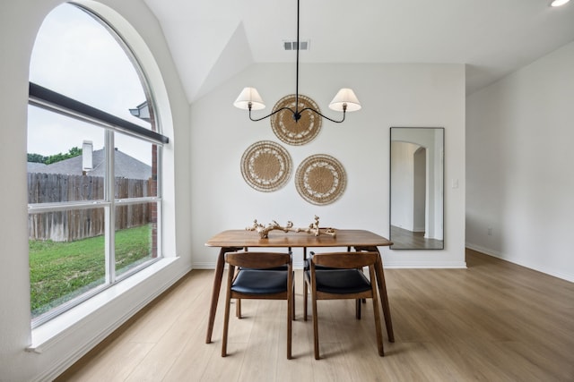 12306 Ark Rd, Frisco, TX 75035 - dining room with a chandelier, light wood-type flooring, lofted ceiling, and baseboards