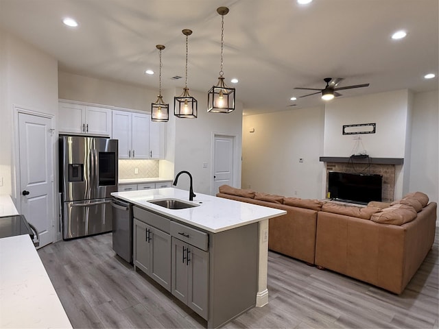 520 Mustang Ln, Pilot Point, TX 76258 - kitchen featuring stainless steel appliances, recessed lighting, a ceiling fan, white cabinetry, and light wood-style floors