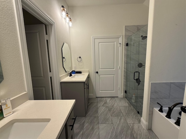 520 Mustang Ln, Pilot Point, TX 76258 - full bath with a stall shower, vanity, a garden tub, marble finish floors, and a textured wall