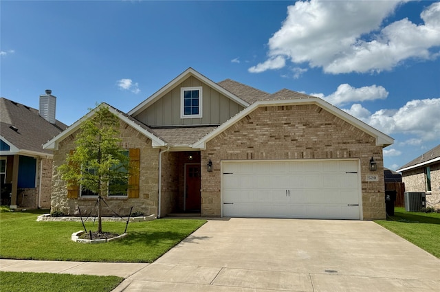 520 Mustang Ln, Pilot Point, TX 76258 - view of front of property with board and batten siding, stone siding, roof with shingles, a front yard, and concrete driveway