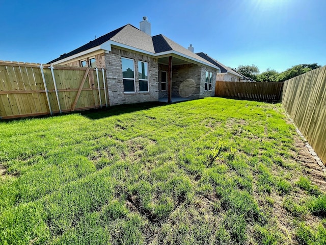 520 Mustang Ln, Pilot Point, TX 76258 - rear view of house with brick siding, a fenced backyard, and a chimney