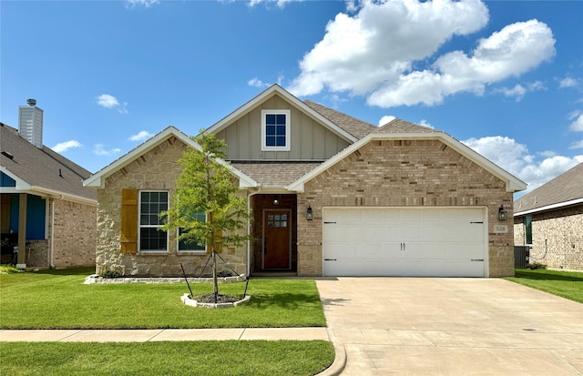 520 Mustang Ln, Pilot Point, TX 76258 - view of front of property with board and batten siding, driveway, roof with shingles, a front lawn, and an attached garage