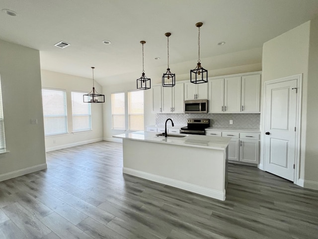 520 Mustang Ln, Pilot Point, TX 76258 - kitchen featuring stainless steel appliances, dark wood-style floors, tasteful backsplash, white cabinets, and light countertops