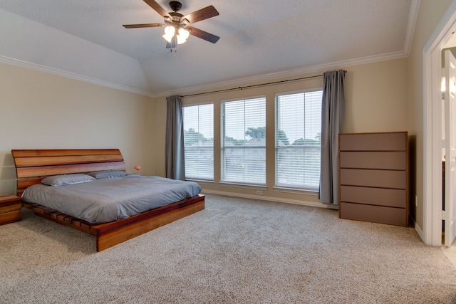 bedroom with carpet flooring, ornamental molding, vaulted ceiling, and ceiling fan
