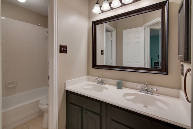 bathroom with tile patterned flooring, toilet, double vanity, shower / washtub combination, and a textured ceiling
