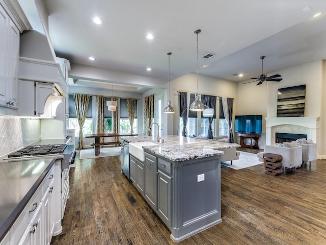 4400 Bristleleaf Ln, Prosper, TX 75078 - kitchen with gray cabinetry, a sink, ceiling fan, dark wood-type flooring, and backsplash