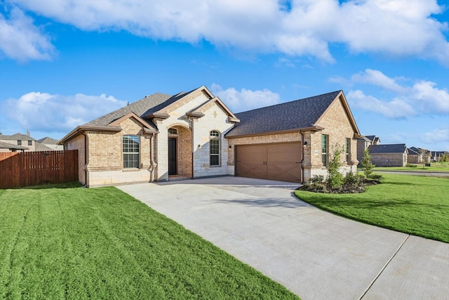 french country home with brick siding, roof with shingles, an attached garage, and concrete driveway