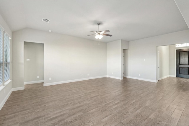 unfurnished living room featuring ceiling fan, wood finished floors, healthy amount of natural light, and lofted ceiling