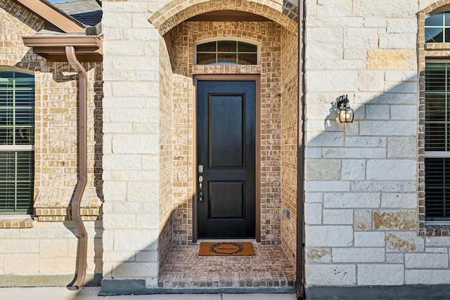 property entrance with stone siding