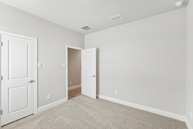 unfurnished bedroom featuring carpet flooring and baseboards