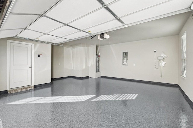 garage featuring a garage door opener, baseboards, and electric panel