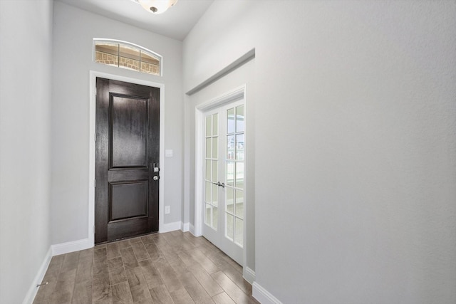 entryway with wood finished floors and baseboards