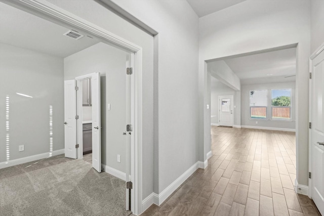 corridor featuring wood finished floors and baseboards