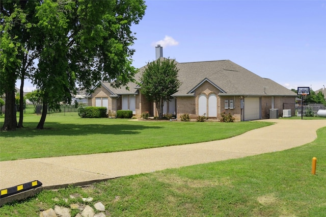 single story home with an attached garage, brick siding, a chimney, central AC unit, and concrete driveway