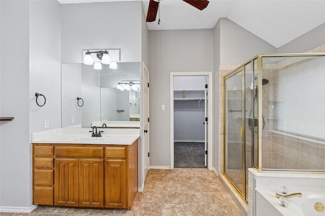 full bathroom with a stall shower, a ceiling fan, vanity, baseboards, and lofted ceiling