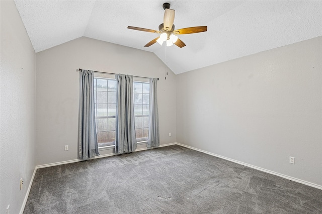 carpeted spare room featuring a ceiling fan, vaulted ceiling, baseboards, and a textured ceiling