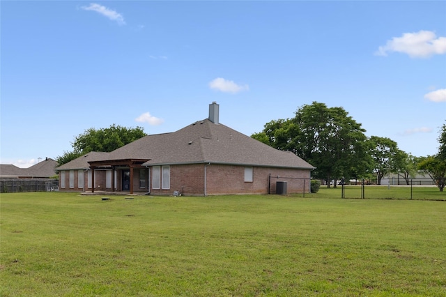 back of property with a chimney, brick siding, and a shingled roof