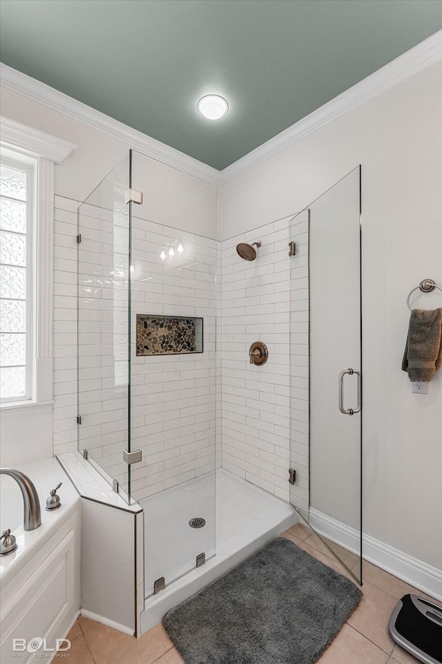 309 Slate Cir, Haughton, LA 71037 - full bathroom with tile patterned flooring, a shower stall, ornamental molding, a garden tub, and baseboards