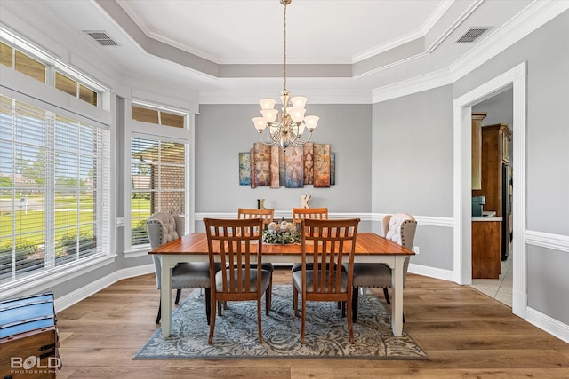 309 Slate Cir, Haughton, LA 71037 - dining area featuring wood finished floors, ornamental molding, a chandelier, a raised ceiling, and baseboards