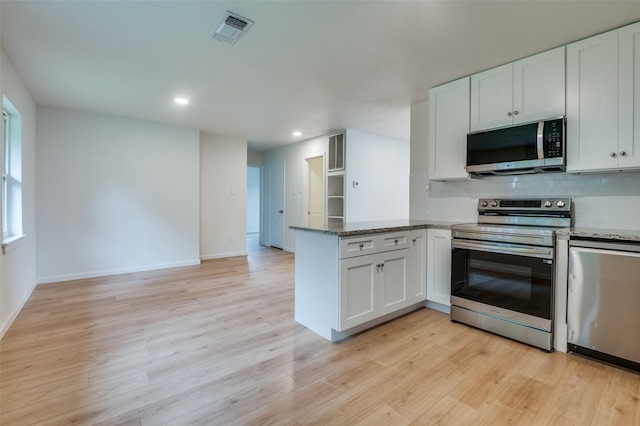 kitchen with stainless steel appliances, a peninsula, decorative backsplash, stone counters, and recessed lighting