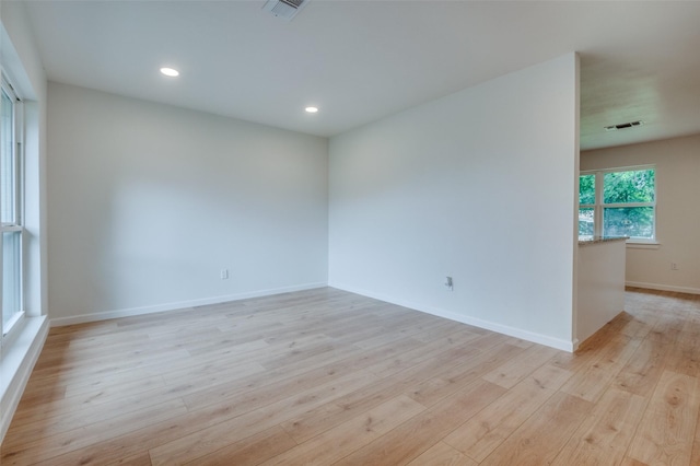 spare room with light wood-style flooring, baseboards, and recessed lighting