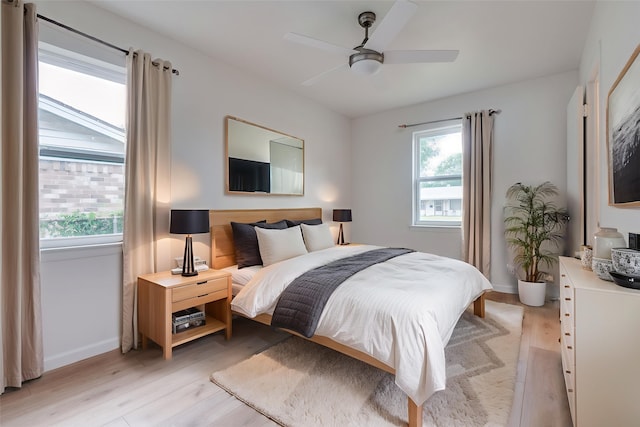 424 Stonewall Dr, Euless, TX 76039 - bedroom with multiple windows, light wood-style flooring, baseboards, and ceiling fan
