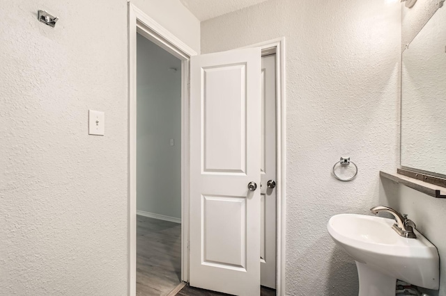 7805 Whitney Dr, White Settlement, TX 76108 - bathroom with a textured wall and a sink