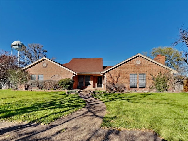 16 Stone Ct, Lakeside, TX 76108 - view of front of property featuring brick siding, a chimney, and a front yard