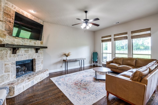120 Crystal Creek Ln, Mckinney, TX 75071 - living area featuring a ceiling fan, baseboards, a stone fireplace, and dark wood finished floors