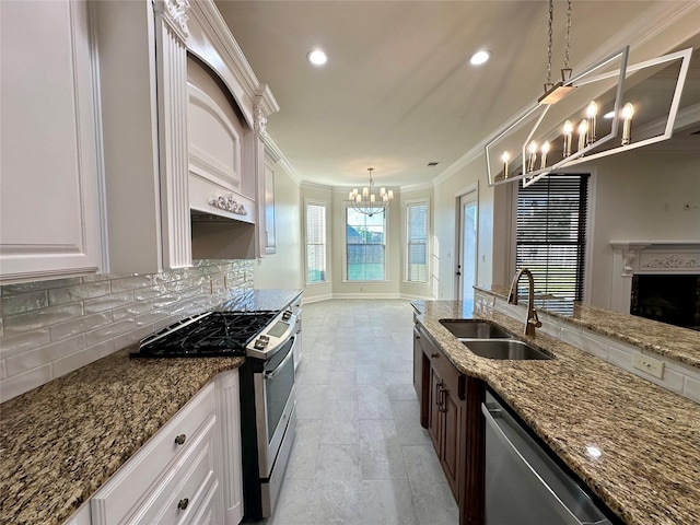 723 Dumaine Dr, Bossier City, LA 71111 - kitchen with a sink, a chandelier, stainless steel appliances, ornamental molding, and backsplash
