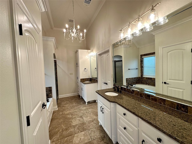 723 Dumaine Dr, Bossier City, LA 71111 - bathroom featuring crown molding, two vanities, a garden tub, a chandelier, and baseboards