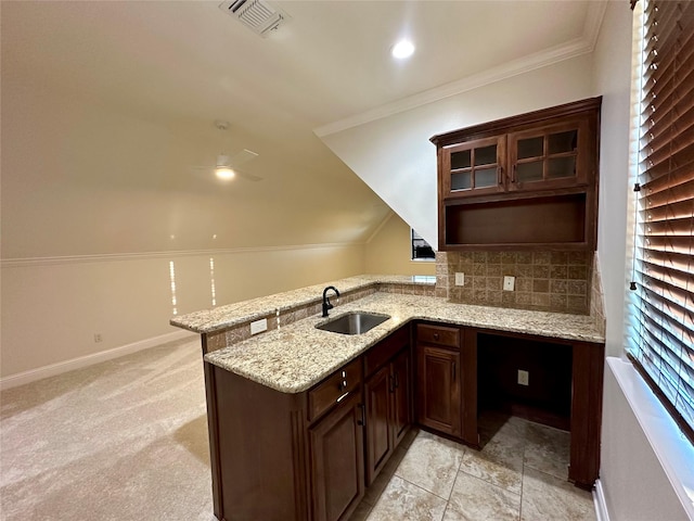 723 Dumaine Dr, Bossier City, LA 71111 - kitchen with a sink, a peninsula, tasteful backsplash, dark brown cabinetry, and light stone countertops