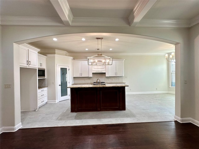 723 Dumaine Dr, Bossier City, LA 71111 - kitchen with ornamental molding, light wood-style floors, stainless steel microwave, white cabinetry, and recessed lighting