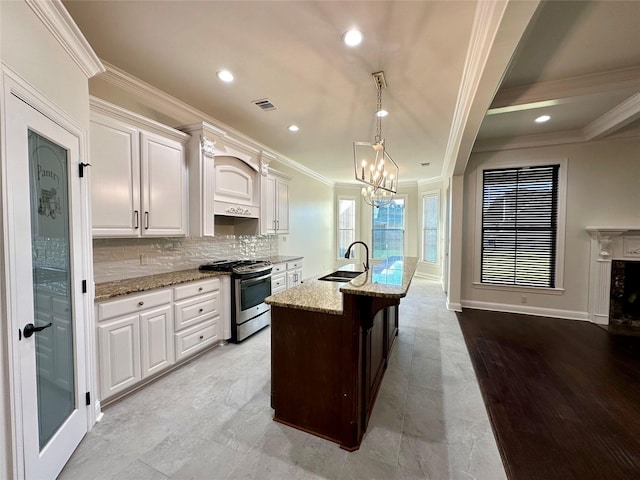 723 Dumaine Dr, Bossier City, LA 71111 - kitchen with stainless steel gas range, a sink, crown molding, light stone countertops, and a chandelier