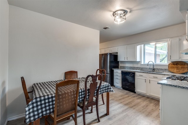 1859 Greendale Dr, Dallas, TX 75217 - kitchen with dishwasher, a sink, light stone counters, and light wood-style floors