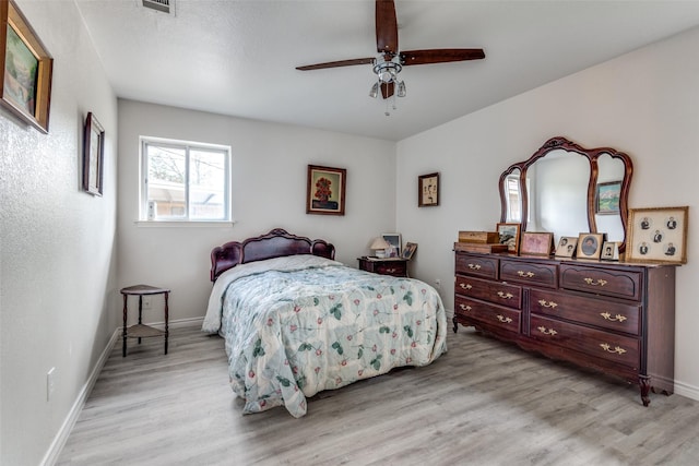 1859 Greendale Dr, Dallas, TX 75217 - bedroom with light wood-type flooring, baseboards, and a ceiling fan
