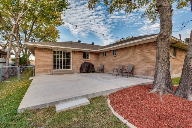 1859 Greendale Dr, Dallas, TX 75217 - back of house featuring a patio, a gate, and brick siding
