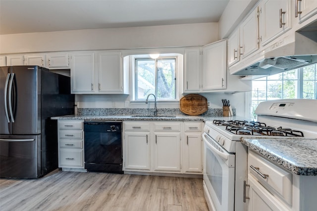 1859 Greendale Dr, Dallas, TX 75217 - kitchen with gas range gas stove, dishwasher, a sink, freestanding refrigerator, and light wood-style floors