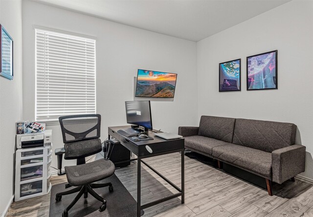 office space with wood finished floors and baseboards