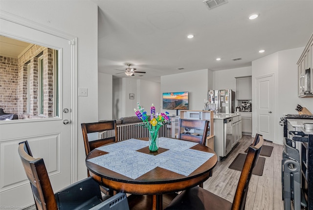 dining space with light wood finished floors, a ceiling fan, and recessed lighting