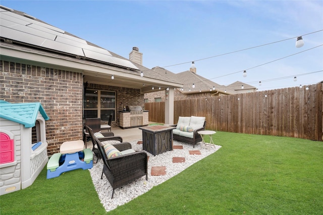 view of yard featuring a patio and an outdoor living space with a fire pit