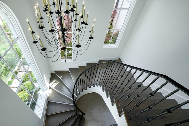 3205 Caruth Blvd, University Park, TX 75225 - stairs featuring a towering ceiling and a chandelier