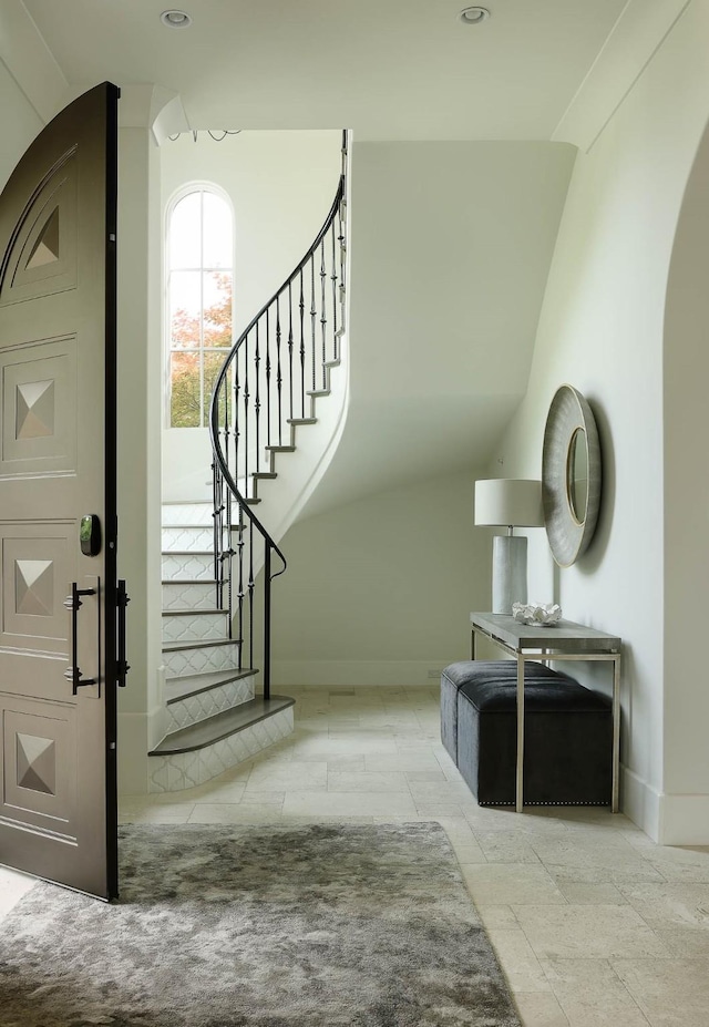 3205 Caruth Blvd, University Park, TX 75225 - stairway with baseboards, arched walkways, and vaulted ceiling