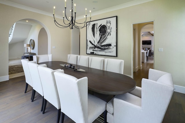 3205 Caruth Blvd, University Park, TX 75225 - dining space with arched walkways, wood finished floors, crown molding, baseboards, and a chandelier