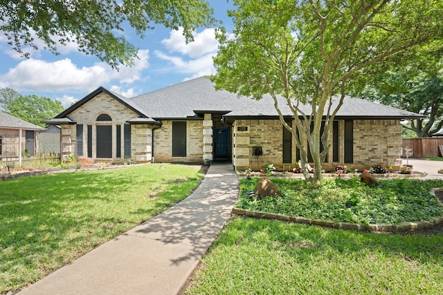 view of front facade with brick siding and a shingled roof