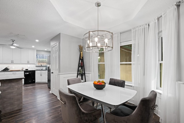 dining area featuring a chandelier, dark wood-type flooring, and a textured ceiling