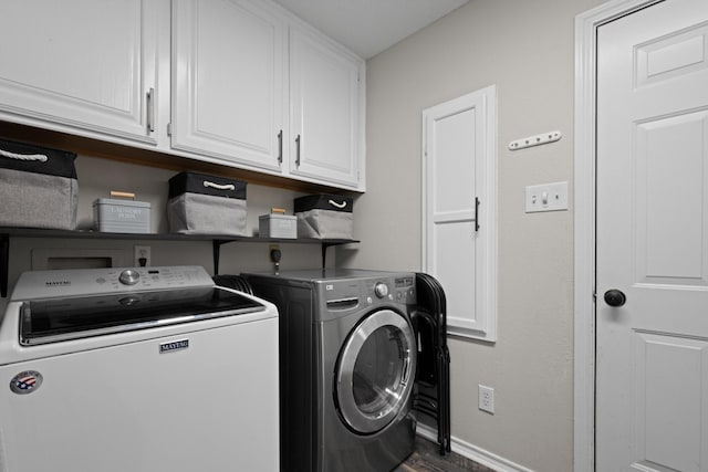 laundry room with separate washer and dryer, cabinet space, baseboards, and dark wood-type flooring