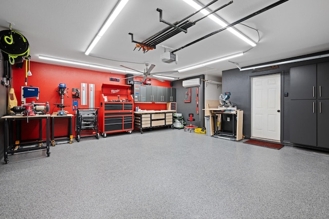 garage featuring a workshop area, a garage door opener, and an AC wall unit