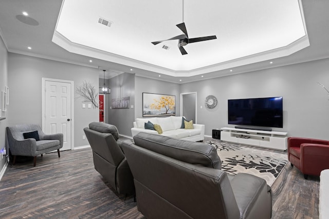 living area with a tray ceiling, dark wood-type flooring, ceiling fan, recessed lighting, and baseboards